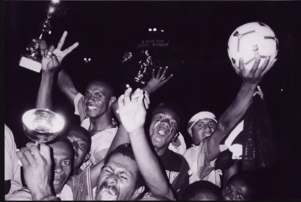 Riding in the back of a truck out to Mele after they won the Futsal comp